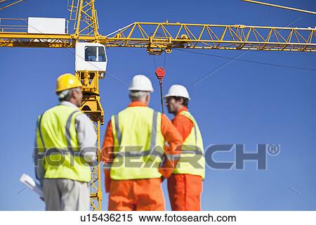 Workers talking at construction site View Large Photo Image Stock Photography - Workers talking at construction site. Fotosearch