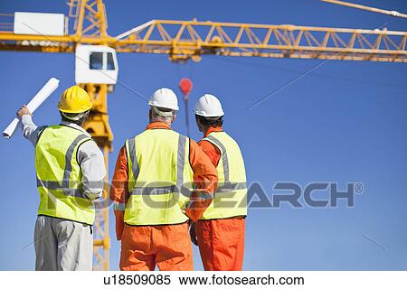 Workers talking at construction site View Large Photo Image Stock Photography - Workers talking at construction site. Fotosearch
