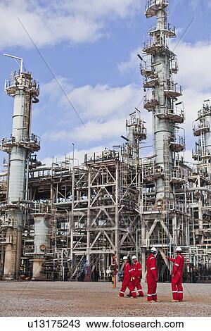 Workers talking at oil refinery View Large Photo Image Stock Image - Workers talking at oil refinery. Fotosearch