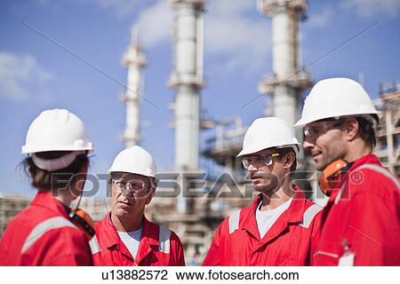Workers talking at oil refinery View Large Photo Image Stock Image - Workers talking at oil refinery. Fotosearch
