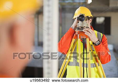 Workers using equipment on site View Large Photo Image Stock Image - Workers using equipment on site. Fotosearch