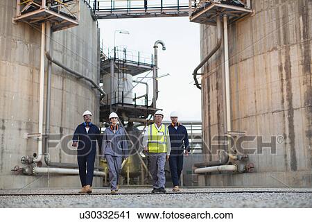 Workers walking at chemical plant View Large Photo Image Stock Image - Workers walking at chemical plant. Fotosearch