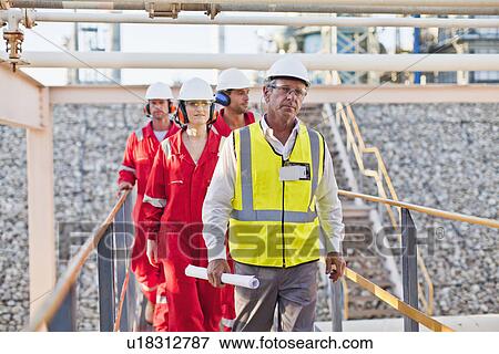 Workers walking at chemical plant View Large Photo Image Stock Photo - Workers walking at chemical plant. Fotosearch