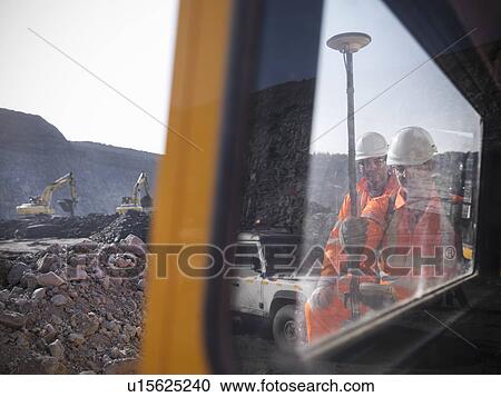 Stock Image - Workers with equipment at coal mine. Fotosearch