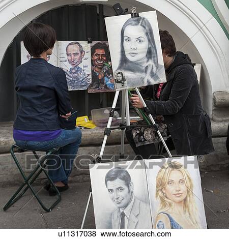 Stock Photo - Artist drawing portrait of a woman in a street, Palace Square, St. Petersburg, Russia. Fotosearch