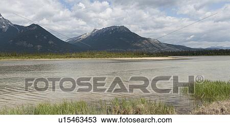 Stock Image - Athabasca River with mountains in the background, Jasper National Park, Alberta, Canada. Fotosearch