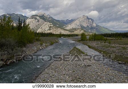 Stock Photo - Athabasca River with mountains in the background, Jasper National Park, Alberta, Canada. Fotosearch