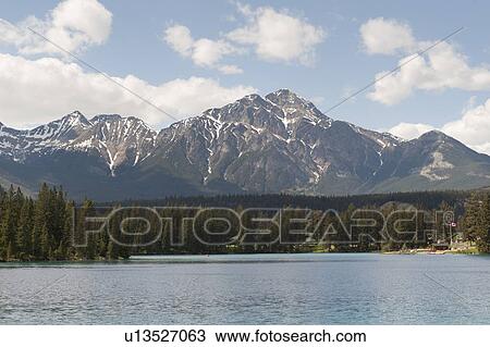 Stock Image - Beauvert Lake with mountains in the background, Jasper National Park, Alberta, Canada. Fotosearch