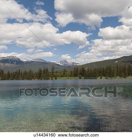 Stock Image - Beauvert Lake with mountains in the background, Jasper National Park, Alberta, Canada. Fotosearch