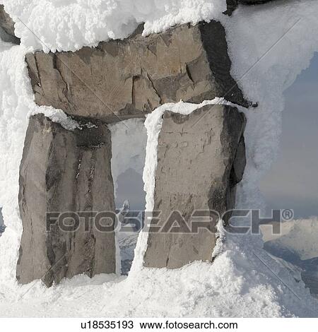Stock Image - Black Tusk viewed through a snow covered inuksuk, Whistler, British Columbia, Canada. Fotosearch