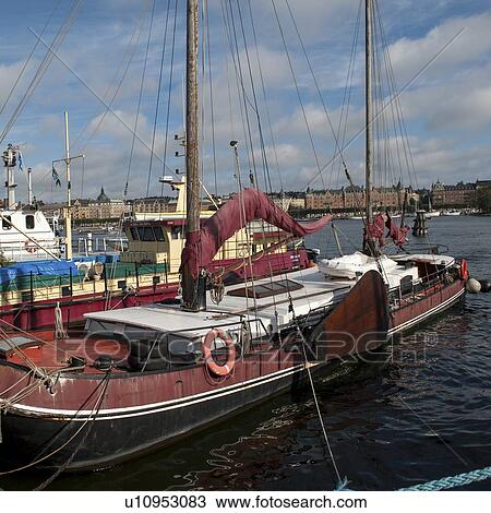 Stock Image - Boats moored at a harbor, Skeppsholmen Island, Stockholm, Sweden. Fotosearch