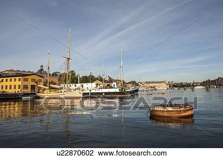 Boats moored at dock with buildings in the background, Skeppsholmen Island, Stockholm, Sweden View Large Photo Image Stock Image - Boats moored at dock with buildings in the background, Skeppsholmen Island, Stockholm, Sweden. Fotosearch