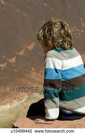 Boy sitting on a rock, Glen Canyon National Recreation Area, Arizona-Utah, USA View Large Photo Image Stock Image - Boy sitting on a rock, Glen Canyon National Recreation Area, Arizona-Utah, USA. Fotosearch