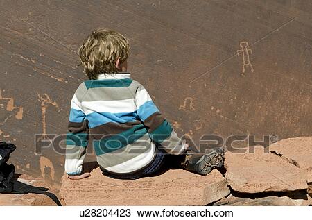 Boy sitting on a rock, Glen Canyon National Recreation Area, Arizona-Utah, USA View Large Photo Image Stock Image - Boy sitting on a rock, Glen Canyon National Recreation Area, Arizona-Utah, USA. Fotosearch