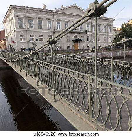 Stock Photograph - Bridge across Moyka River with Mariinsky Palace in the background, St. Petersburg, Russia. Fotosearch