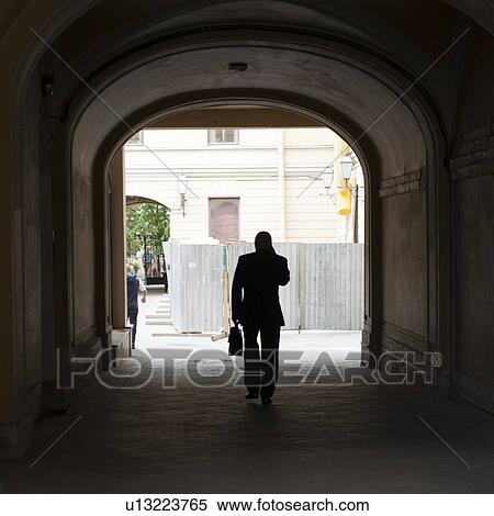 Businessman walking under a tunnel, St. Petersburg, Russia View Large Photo Image Stock Photography - Businessman walking under a tunnel, St. Petersburg, Russia. Fotosearch