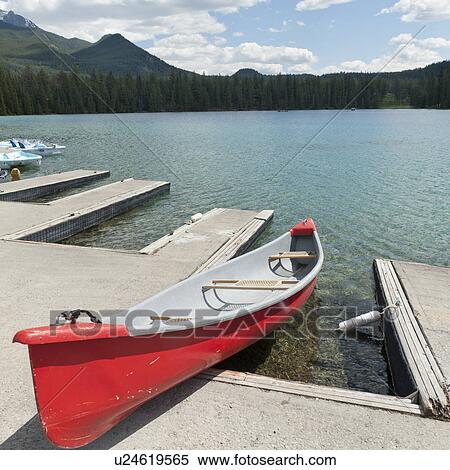 Stock Photography - Canoe at dock in Beauvert Lake, Jasper National Park, Alberta, Canada. Fotosearch