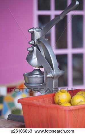 Stock Image - Citrus juicer with oranges at a stall, Sayulita, Nayarit, Mexico. Fotosearch