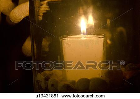 Stock Image - Close-up of a burning candle in a glass jar, Sayulita, Nayarit, Mexico. Fotosearch