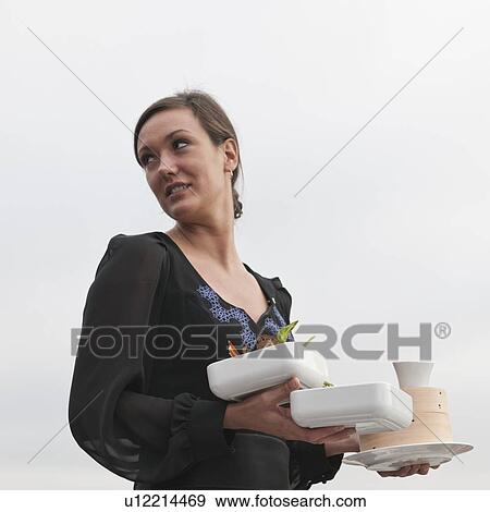 Close-up of a woman carrying bowls of food, St. Petersburg, Russia View Large Photo Image Stock Photo - Close-up of a woman carrying bowls of food, St. Petersburg, Russia. Fotosearch