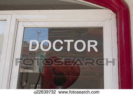 Stock Image - Close-up of doctor sign on the door, Sayulita, Nayarit, Mexico. Fotosearch