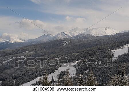 Clouds over snow covered mountains, British Columbia, Canada View Large Photo Image Stock Photo - Clouds over snow covered mountains, British Columbia, Canada. Fotosearch