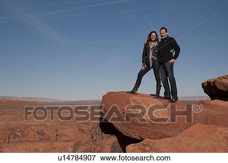 Couple standing on a rock, Horseshoe Bend, Glen Canyon National Recreation Area, Arizona-Utah, USA View Large Photo Image Stock Photo - Couple standing on a rock, Horseshoe Bend, Glen Canyon National Recreation Area, Arizona-Utah, USA. Fotosearch