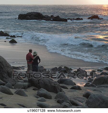 Stock Photo - Couple standing on the beach, Sayulita, Nayarit, Mexico. Fotosearch