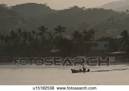 Stock Photo - Fishing boat leaving the beach, Sayulita, Nayarit, Mexico. Fotosearch