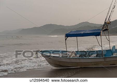 Stock Image - Fishing boat on the beach, Sayulita, Nayarit, Mexico. Fotosearch