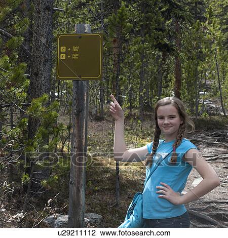 Stock Image - Girl pointing at the signboard of Bald Hills Trail, Jasper National Park, Alberta, Canada. Fotosearch