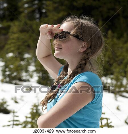 Stock Photo - Girl shielding eyes, Bald Hills, Jasper National Park, Alberta, Canada. Fotosearch