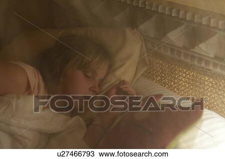 Stock Image - Girl sleeping on the bed, Sayulita, Nayarit, Mexico. Fotosearch