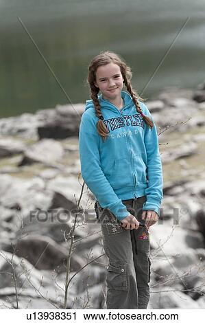 Stock Image - Girl smiling at the lakeside, Medicine Lake, Jasper National Park, Alberta, Canada. Fotosearch