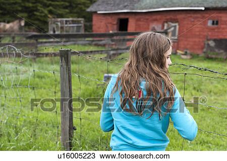 Girl standing near a fence, Northern Alberta, Alberta, Canada View Large Photo Image Stock Image - Girl standing near a fence, Northern Alberta, Alberta, Canada. Fotosearch