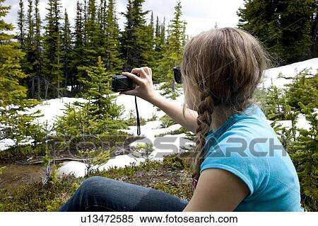 Stock Photography - Girl taking picture with a digital camera, Bald Hills Trail, Jasper National Park, Alberta, Canada. Fotosearch