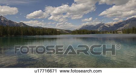 Stock Image - Lake with mountains in the background, Jasper National Park, Alberta, Canada. Fotosearch