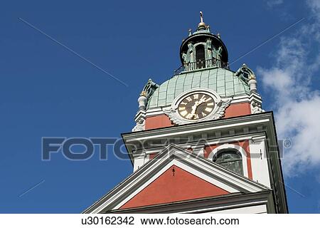 Stock Image - Low angle view of a clock tower at St. James's Church, Stockholm, Sweden. Fotosearch
