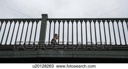 Low angle view of a man on a bridge, St. Petersburg, Russia View Large Photo Image Stock Image - Low angle view of a man on a bridge, St. Petersburg, Russia. Fotosearch