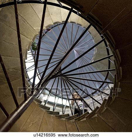 Stock Photography - Low angle view of a woman standing on spiral staircase of the Saint Isaac's Cathedral, St. Isaac's Square, St. Petersburg, Russia. Fotosearch