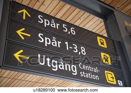 Stock Image - Low angle view of directional signs at a station, Uppsala, Sweden. Fotosearch