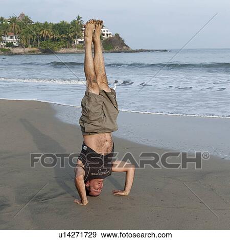 Man doing handstand on the beach, Sayulita, Nayarit, Mexico View Large Photo Image Stock Photo - Man doing handstand on the beach, Sayulita, Nayarit, Mexico. Fotosearch