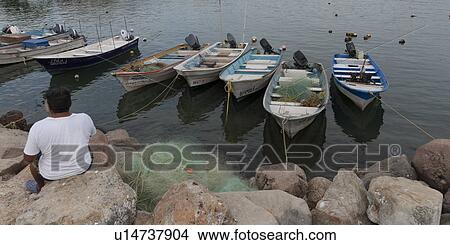 Picture - Man sitting on a rock, Sayulita, Nayarit, Mexico. Fotosearch
