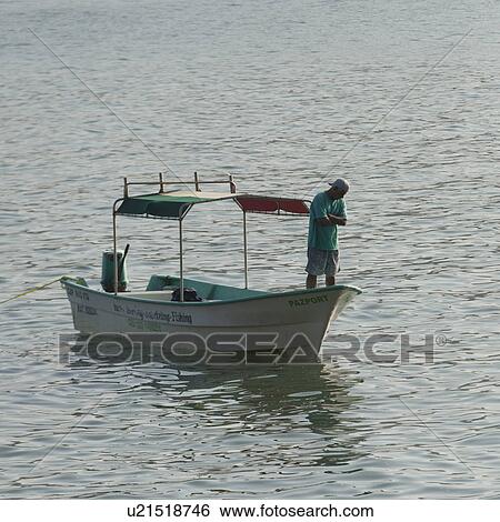 Man standing on a boat in the sea, Sayulita, Nayarit, Mexico View Large Photo Image Stock Photograph - Man standing on a boat in the sea, Sayulita, Nayarit, Mexico. Fotosearch