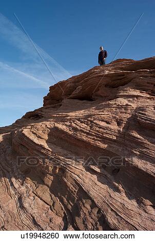 Man standing on a rock, Horseshoe Bend, Glen Canyon National Recreation Area, Arizona-Utah, USA View Large Photo Image Stock Image - Man standing on a rock, Horseshoe Bend, Glen Canyon National Recreation Area, Arizona-Utah, USA. Fotosearch