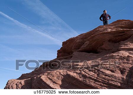 Stock Photography - Man standing on a rock, Horseshoe Bend, Glen Canyon National Recreation Area, Arizona-Utah, USA. Fotosearch