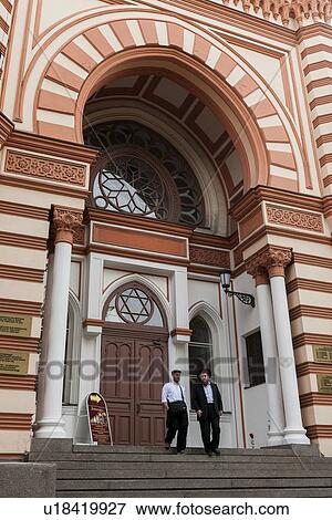 Stock Photo - Men moving down steps of the Grand Choral Synagogue, St. Petersburg, Russia. Fotosearch