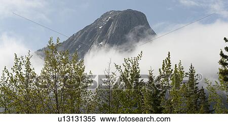 Stock Photography - Mountain peak surrounded with clouds, Jasper National Park, Alberta, Canada. Fotosearch