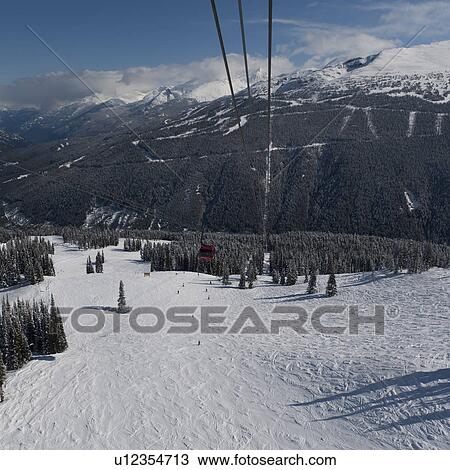 Stock Image - Peak 2 Peak Gondolas over snow covered mountains, Whistler, British Columbia, Canada. Fotosearch