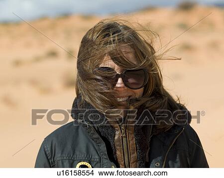 Picture - Portrait of a woman smiling, Coral Pink Sand Dunes State Park, Utah, USA. Fotosearch